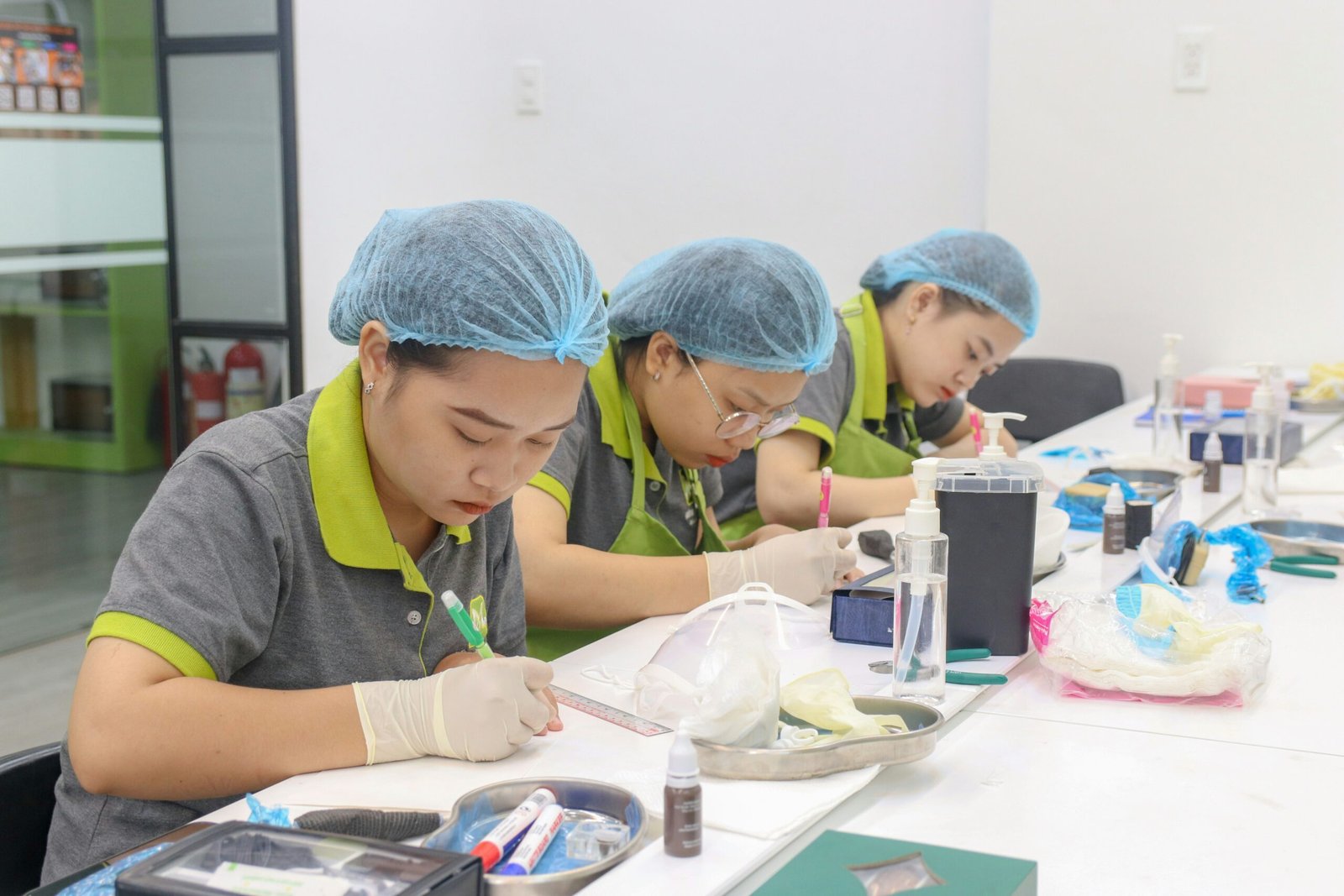 A group of people sitting at a table working on something